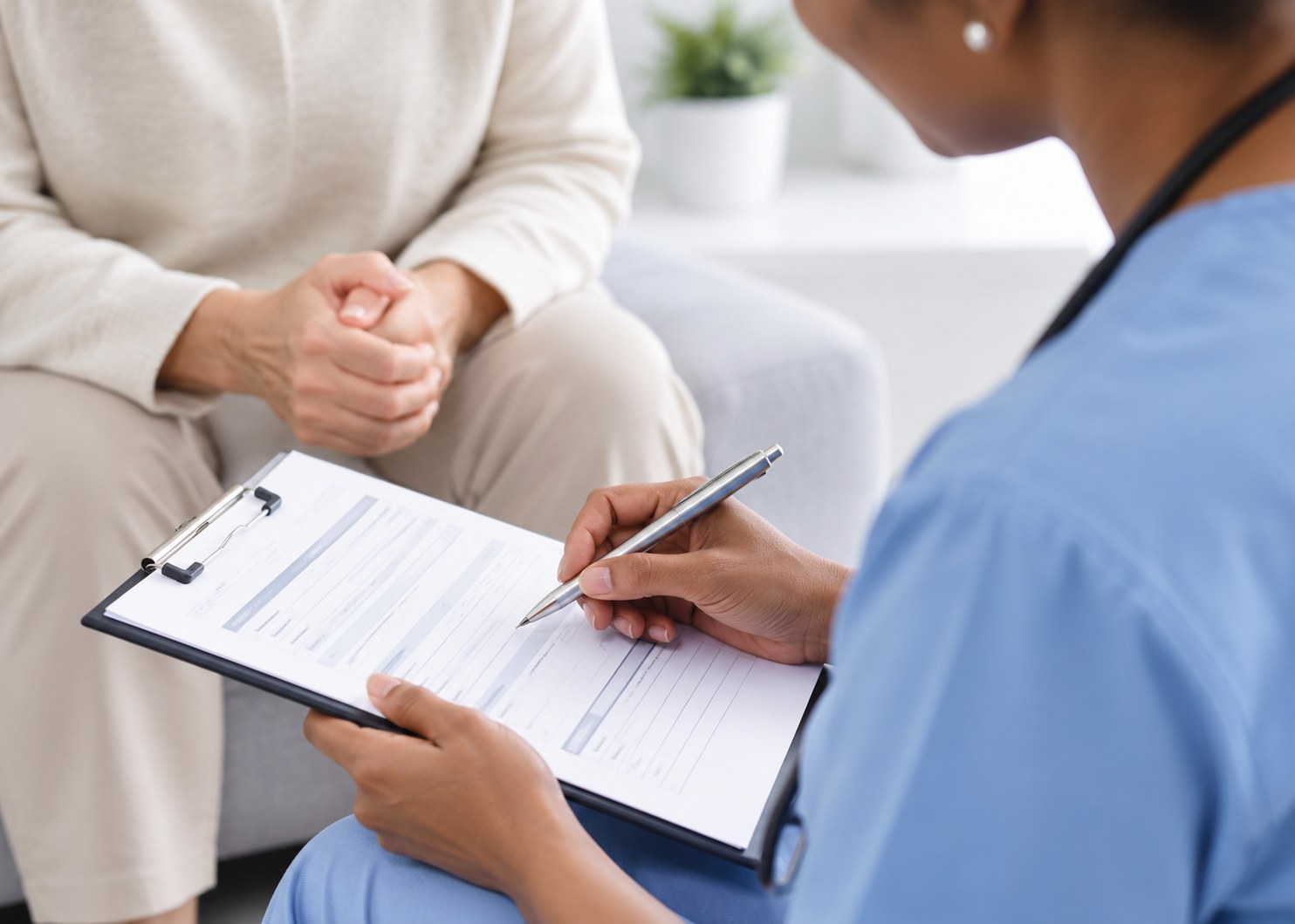 Illustrative stock photo of a clinician reviewing paperwork during a consultation, not Peak staff
